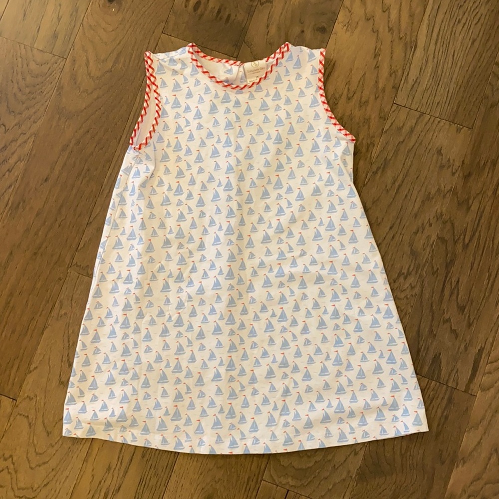Sailboat printed cotton dress with red plaid details on sleeves and neckline.